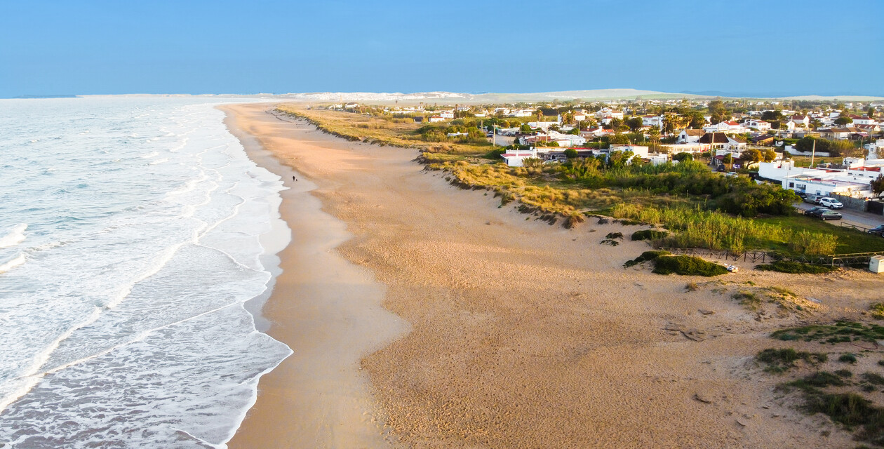 Surfing on the empty beach in El Palmar