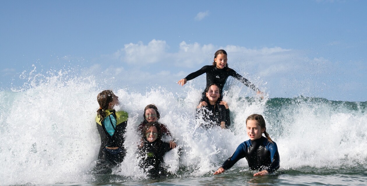 Children on a surf course at a family surf camp in Spain