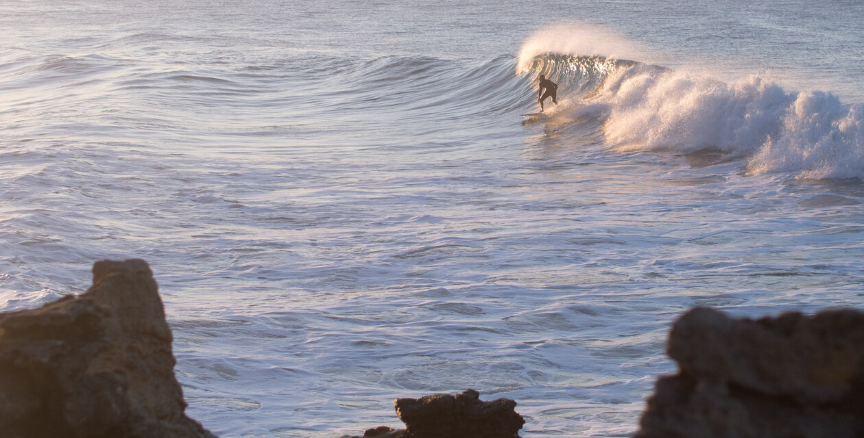 buy surfboard, man with surfboard on the beach