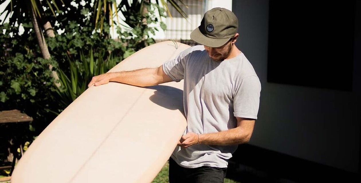 Shaper Phil with surfboard in hand