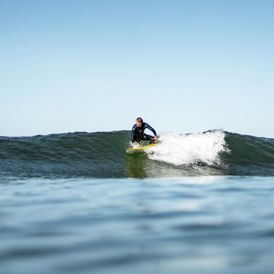 Surfers in a green wave at El Palmar surf camp