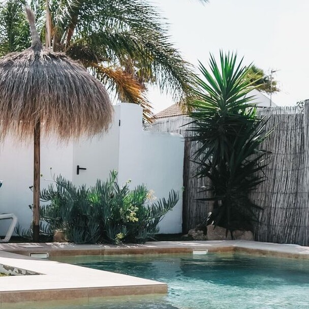 Oasis Surfcamp Spanien mit Palmen und Pool