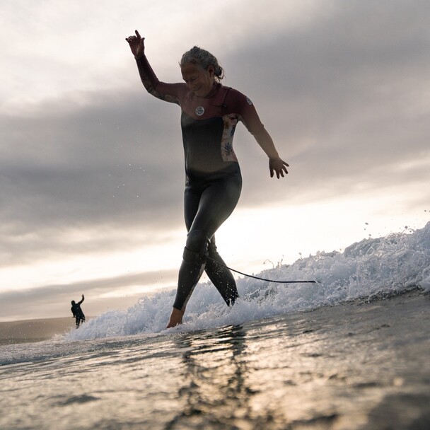 Surfing with a longboard at A-Frame in the surf course