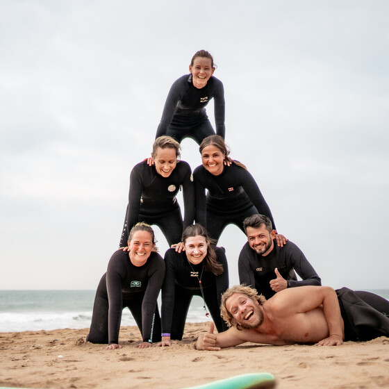 Human pyramid on the beach, fun after the surf course