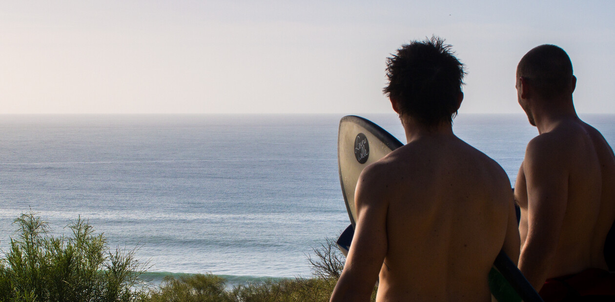 Two surfers at the surf spot check