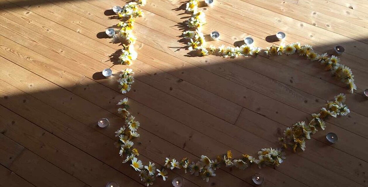 Heart made of flowers and candles with the yoga species