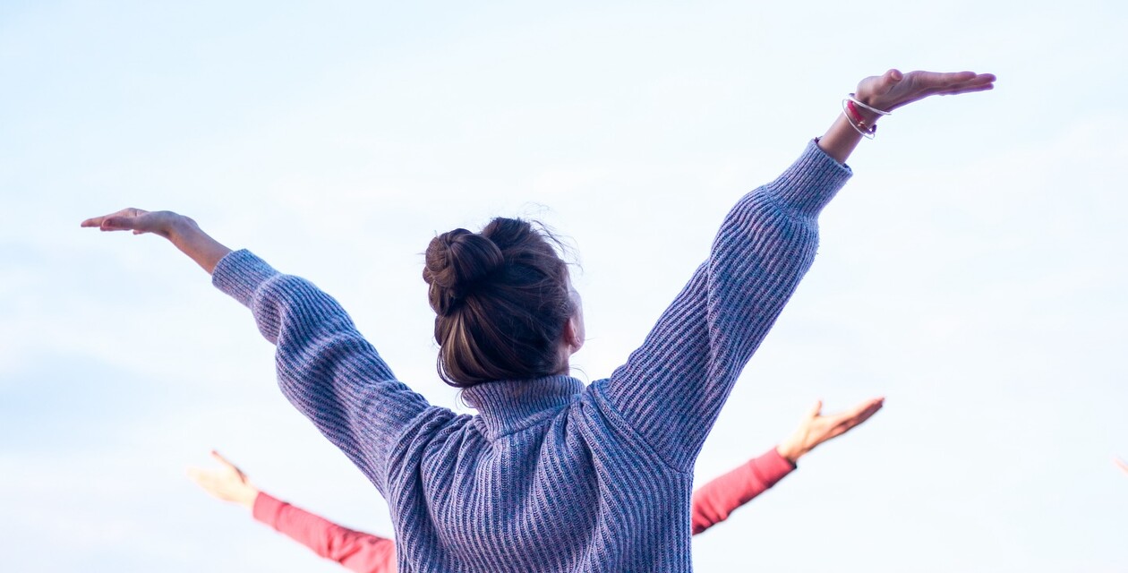 Woman does yoga in El Palmar and stretches her hands to the sky