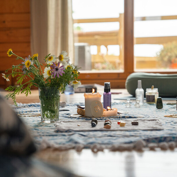 Close-up of a decorated table with flowers in the yoga area