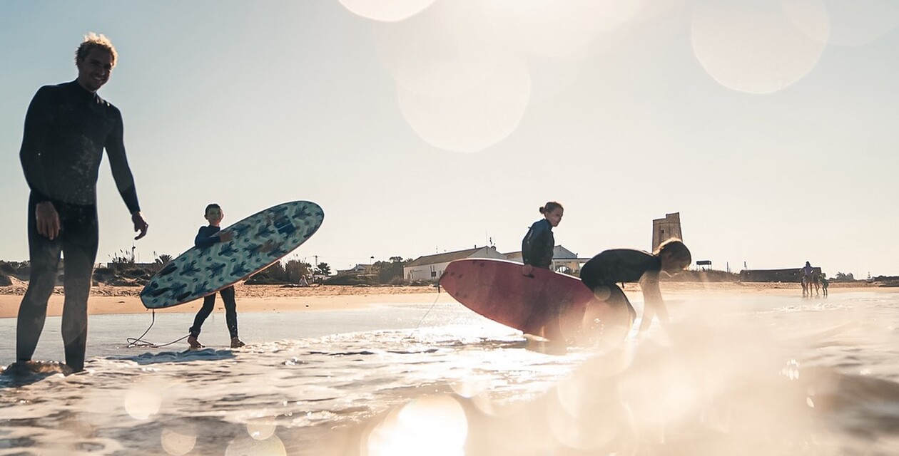 Sunset and surfers, yoga retreat in southern Spain