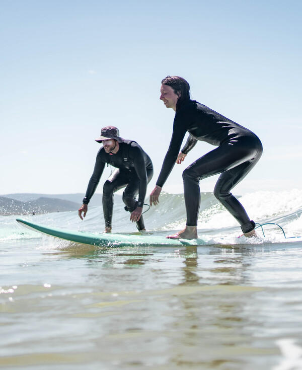 Surf camp with surf course, accommodation, catering, surf students in the water