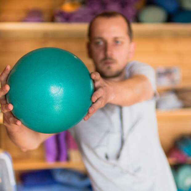 Surf fitness exercises, man holding ball