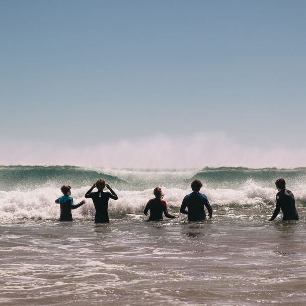 Andalusia surf camp, A-frame surf students with waves in the background