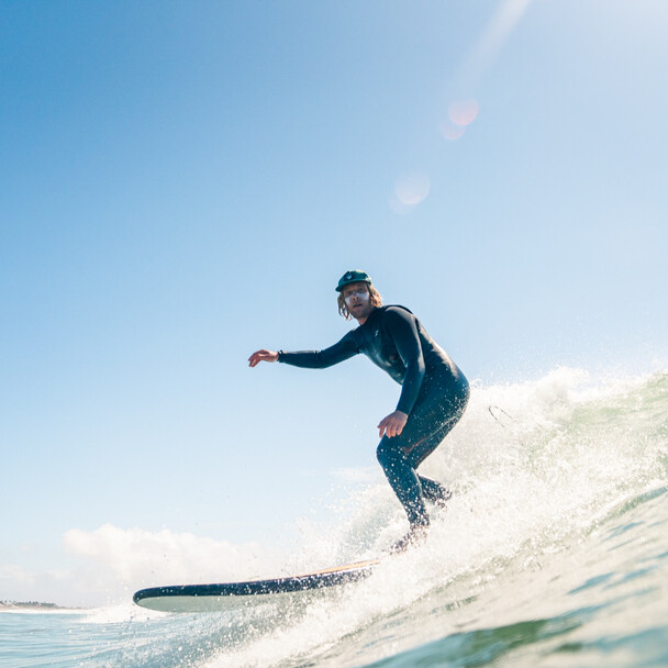 Surf camp Spain Andalusia, surf instructors in waves in the sunshine