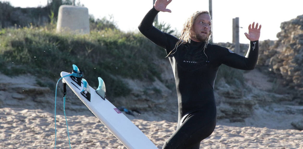 Surf instructor training Aframe, surfer shows movement exercises