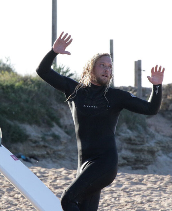 Surf instructor training Aframe, surfer shows movement exercises