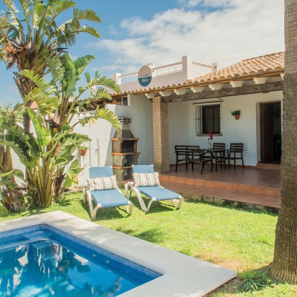 Oasis accommodation Surfcamp El Palmar, garden with pool and sun loungers