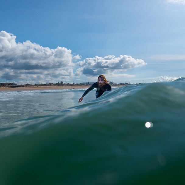 Surfer on a wave at the surf spot in El Palmar