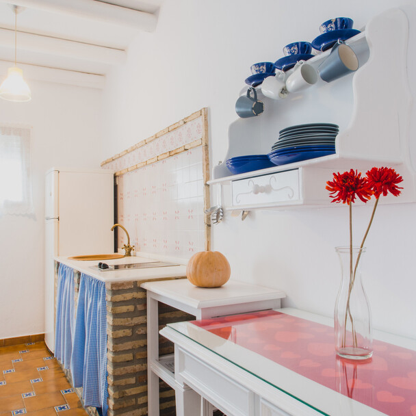 Cozy kitchen with flowers in the surf camp Andalusia