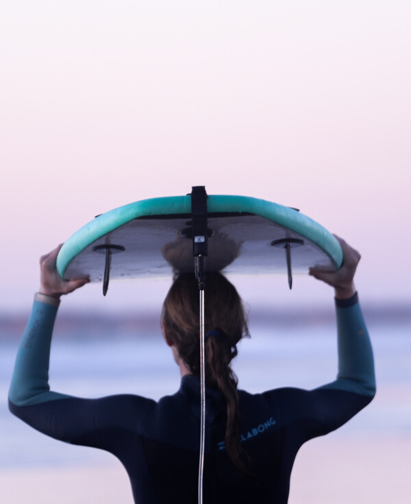 Yoga surf retreat, yoga and surfing, woman with surfboard