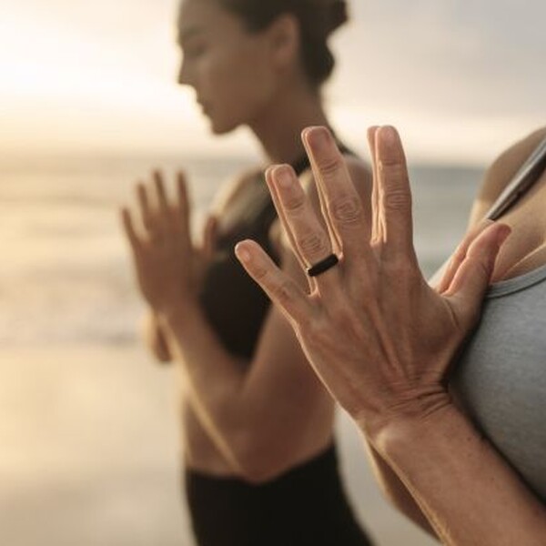 Yoga retreat in Spain, women do yoga on the beach