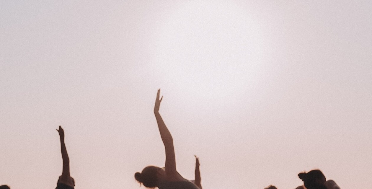 Hormone yoga menopause in the sunset on the beach